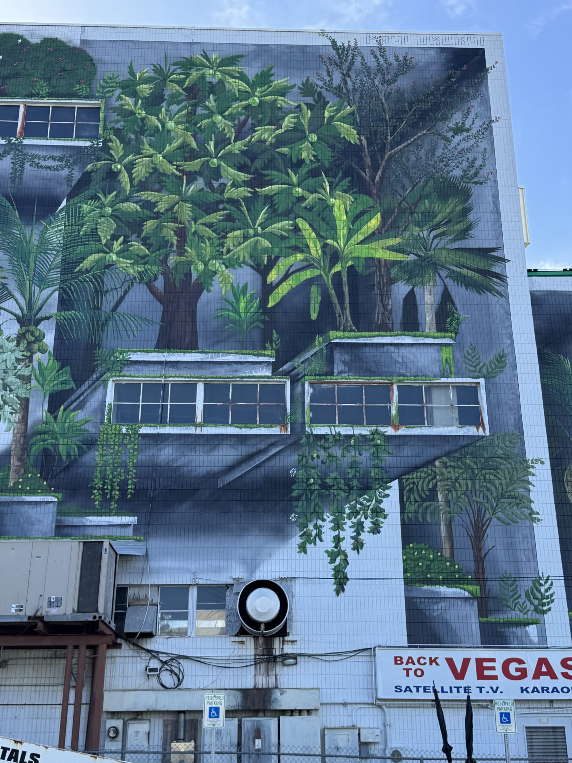 Wao Kānaka mural closeup of ʻulu tree, niu, ʻōhiʻa lehua